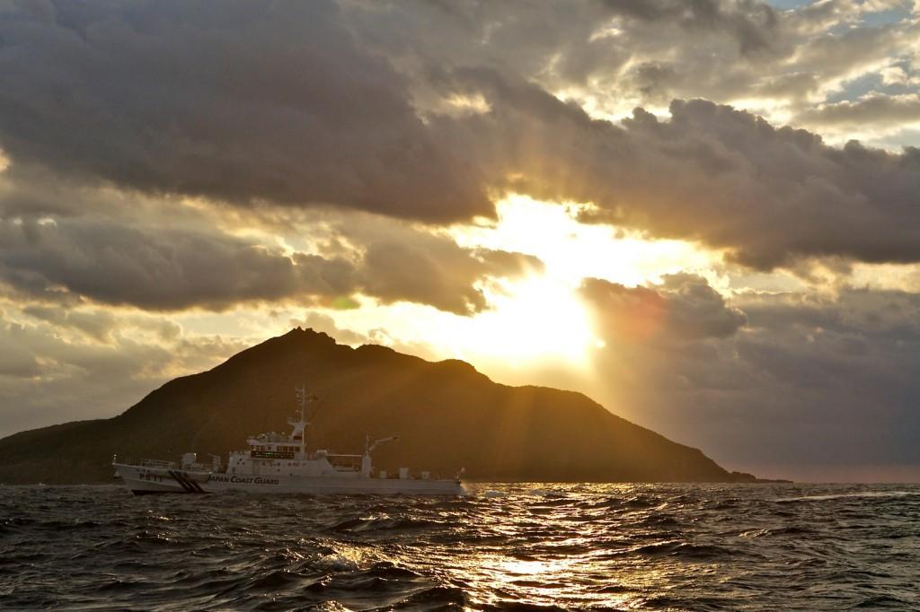 A Japanese Coast Guard patrol vessel passes by Uotsuri, the largest island in the Senkaku/Diaoyu chain.
