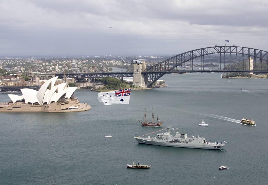 A Navy Seahawk helicopter from 816 Squadron, flys the Australian White Ensign over Sydney Harbour while Chief of Navy Vice Admiral Ray Griggs, AO CSC, RAN launches the Royal Australian Navy's International Fleet Review 2013 on board HMAS Parramatta in Sydney Harbour.