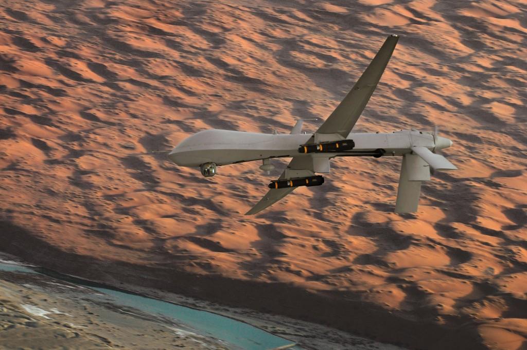 An MQ-1 Predator unmanned aircraft, armed with AGM-114 Hellfire missiles, flies a combat mission over southern Afghanistan