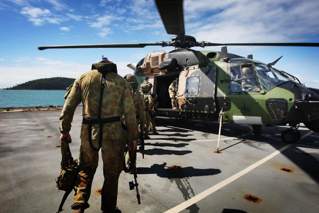 Soldiers from 2RAR board an MRH90 helicopter on the deck of HMAS Choules as they prepare to be inserted onto a beach in the AO of Exercise Sea Lion 2013. Will a new defence strategy focused on trade significantly change the current force structure?