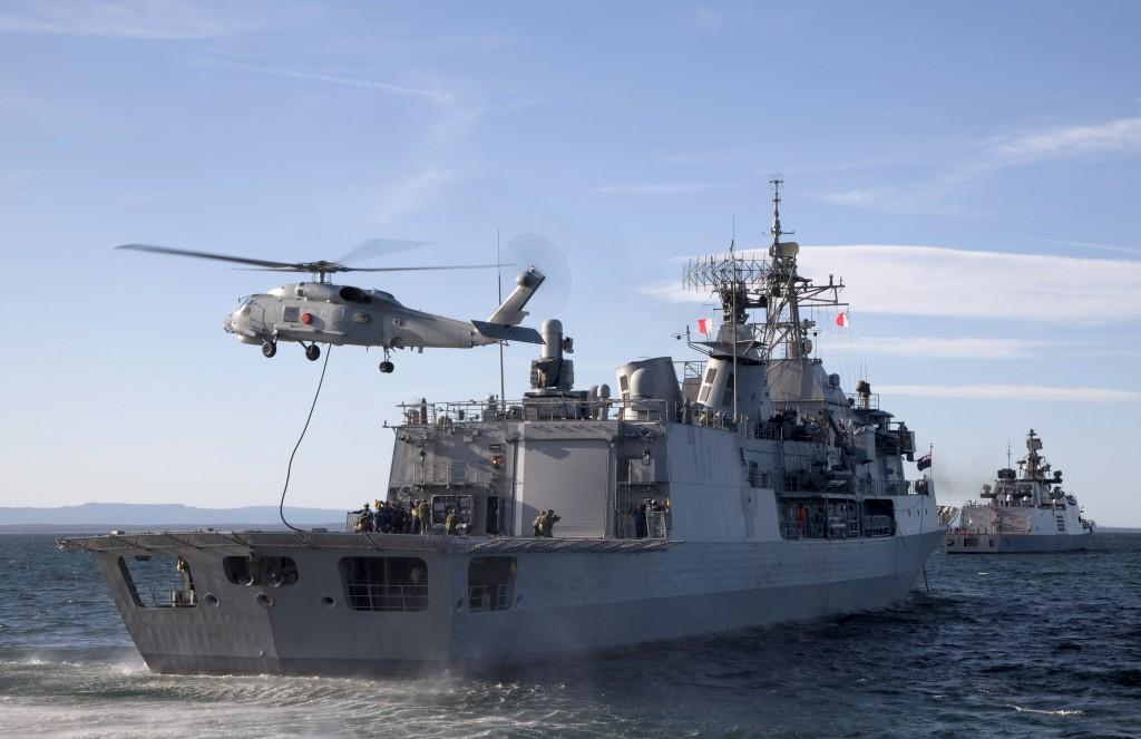 HMNZS Te Mana of the Royal New Zealand Navy receives a Royal Australian Navy boarding party fast roping onto the flight deck of HMNZS Te Mana from an Seahawk helicopter from 816 Squadron.