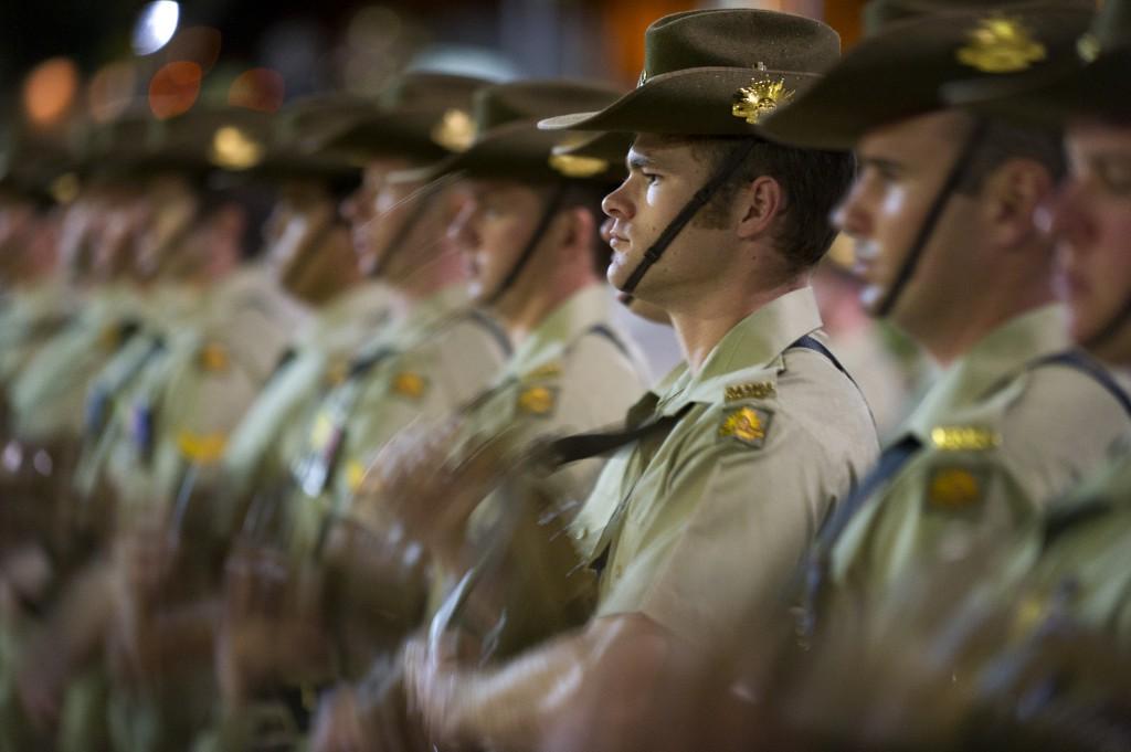 Members of the 1st Signal Regiment, who formed the guard of honour for the centenary parade, prepare to present arms as they commemorate 100 years since the inception of the 1st Division.