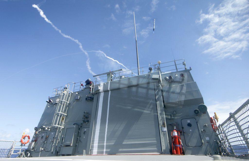 HMAS Perth launches the Nulka missile decoy system during the surface-to-air missile exercise (SAMEX) during Exericise Rim of the Pacific (EX RIMPAC 12). Mid Caption: During Exercise RIMPAC 12, HMAS Perth conducted a surface-to-air missile exercise (SAMEX) about 40 miles off the island of Kauai in the Pacific Missile Range Facility in Hawaii. HMAS Perth used the recently installed phased array missile defence radar to launch two evolved sea sparrow surface to air missiles (ESSM) to hit targets launched from Kauai Island during the missile firing exercise. **Extracted from Video**